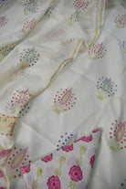 Floral patterned fabric with pink flowers and green leaves on a white background