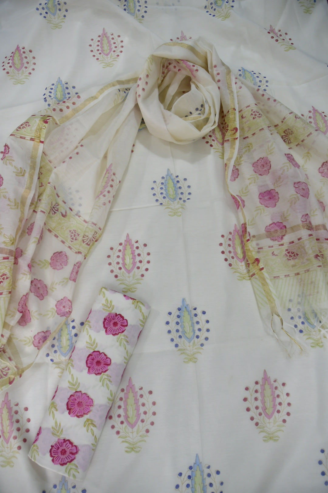 Floral patterned chanderi suit with pink flowers and colorful designs on a white background