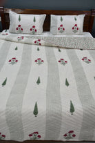 Bed with floral and striped patterned bedding