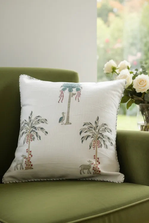 Decorative Cushion cover with palm tree design on a green chair