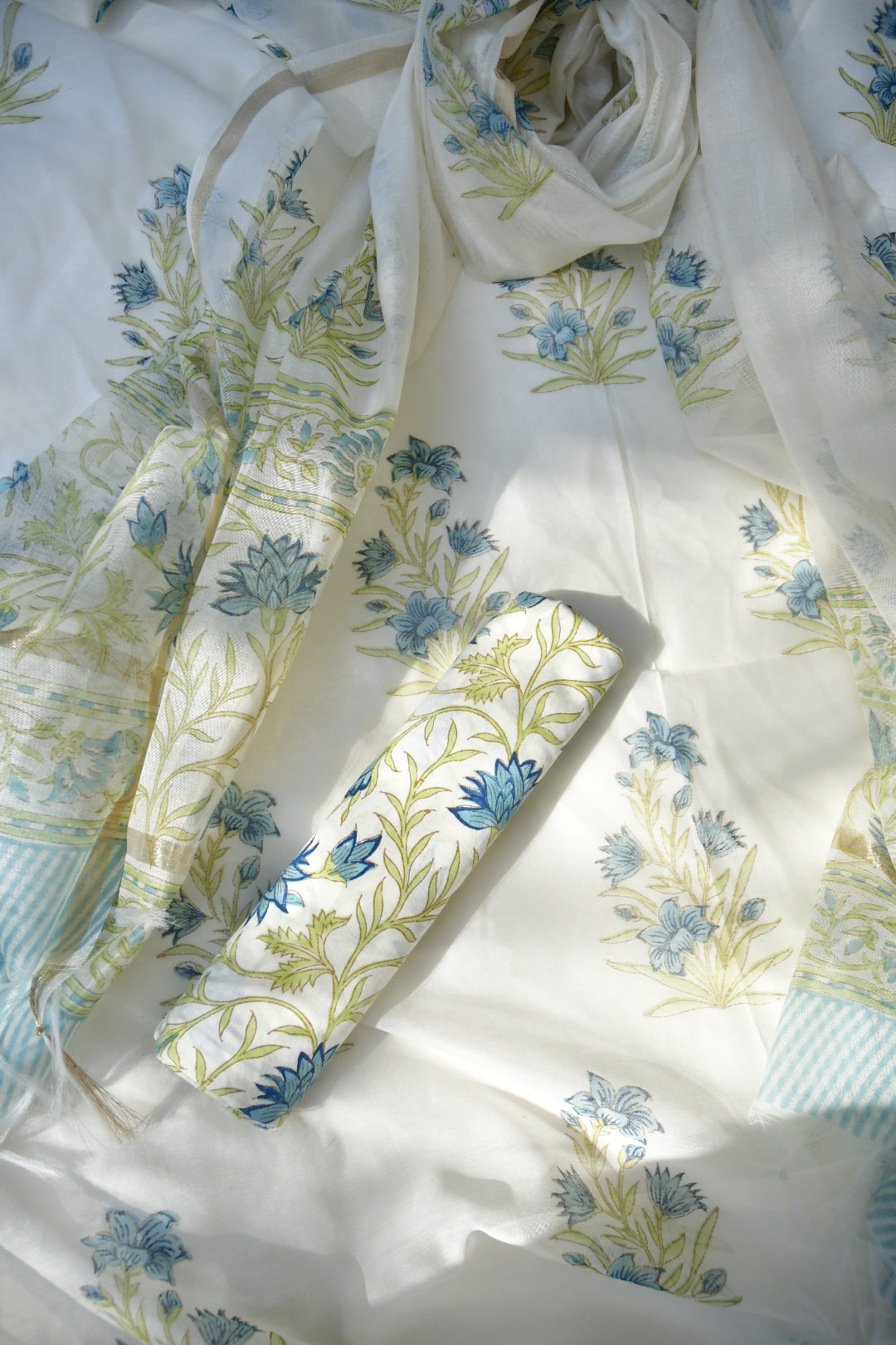 Floral fabric with blue and green patterns on a white background