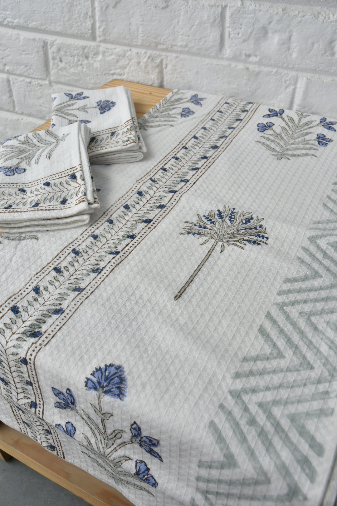 Embroidered tablecloth with floral patterns on a wooden surface