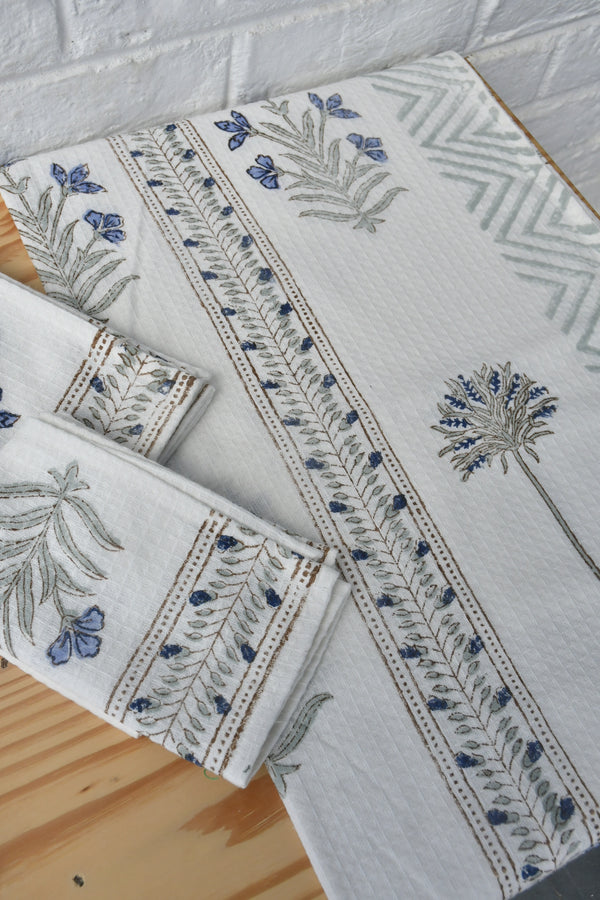 Set of embroidered fabric items on a wooden surface