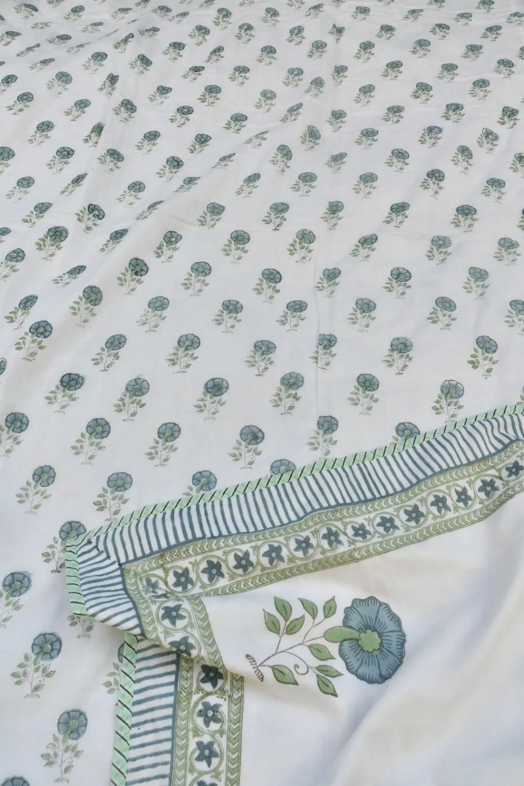 Floral patterned Dohar with green and blue colors on a white background