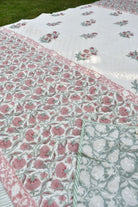 Floral patterned fabric with pink and green colors on a grassy background