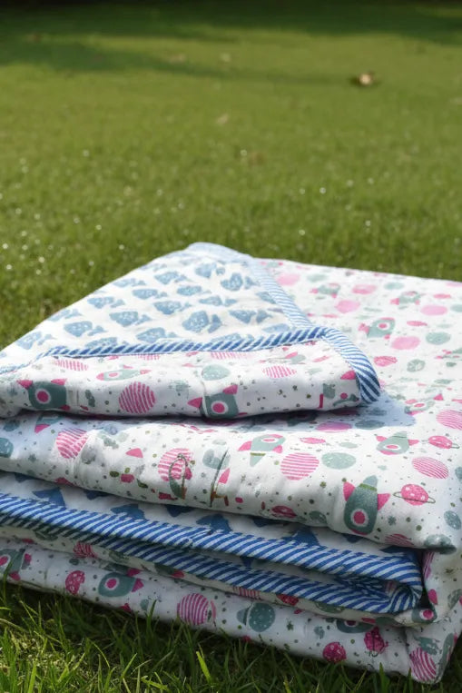 Stack of patterned blankets on grass