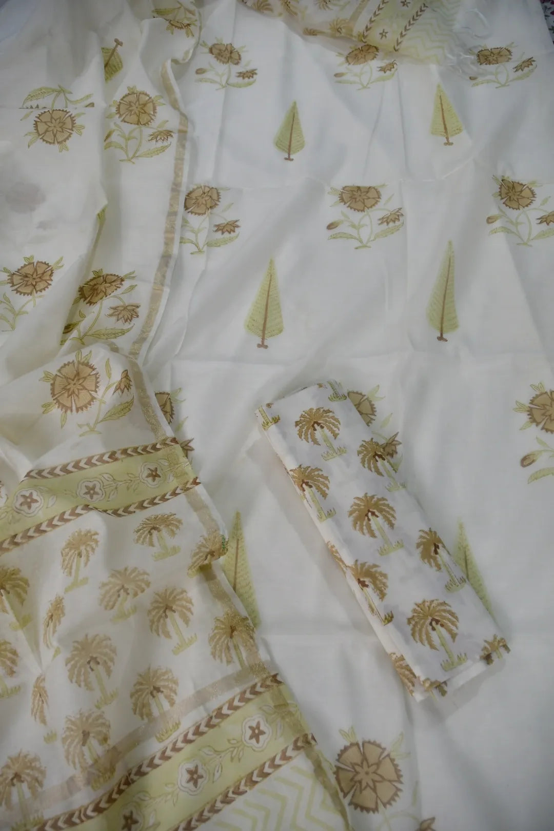 White Chanderi with green floral patterns on a white background