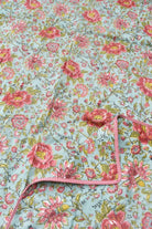 Floral fabric with pink flowers on a light blue background