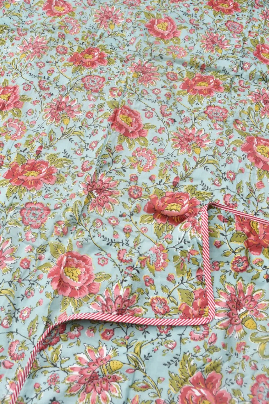 Floral fabric with pink flowers on a light blue background