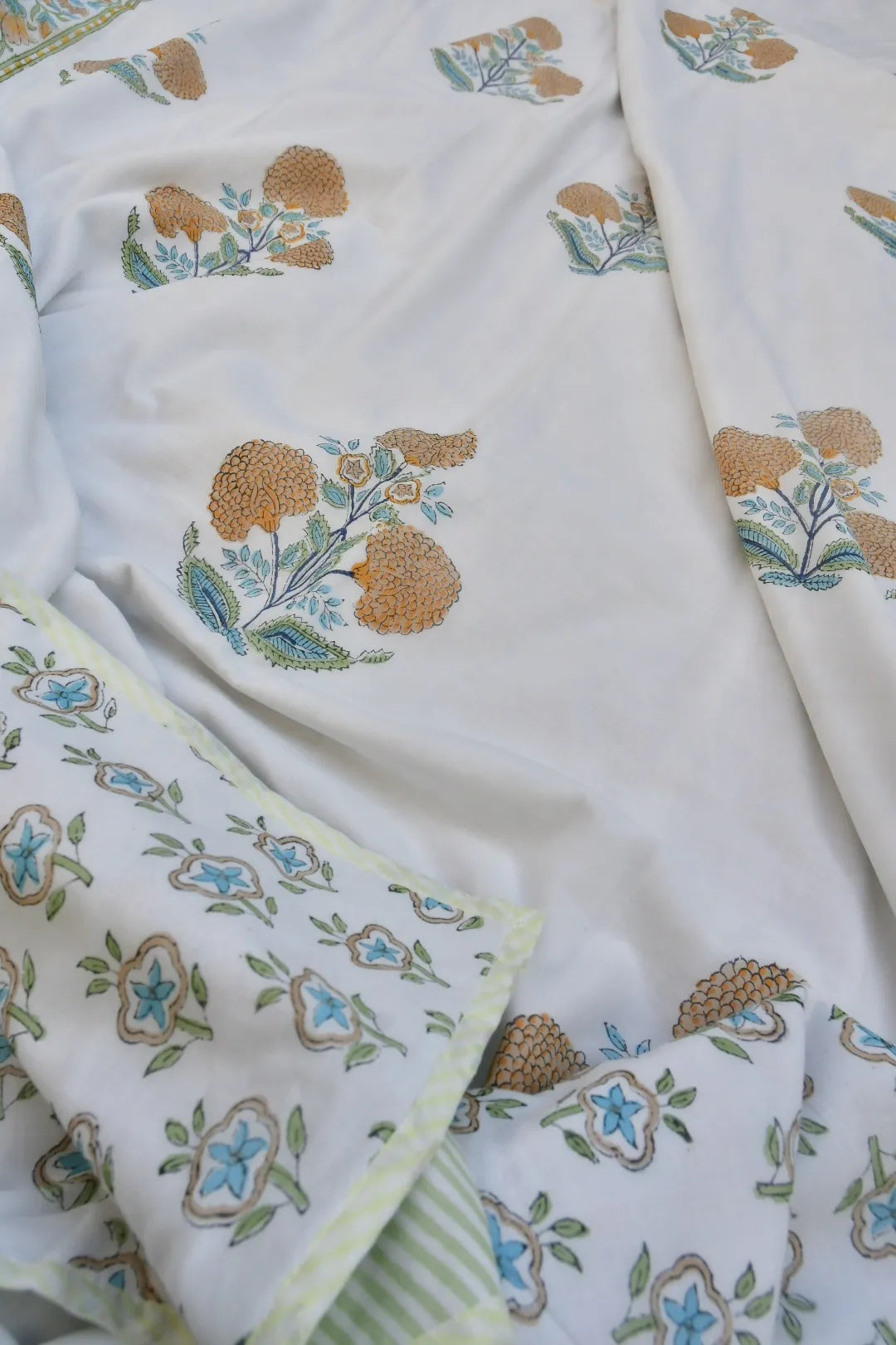 Floral patterned fabric with embroidered designs on a white background