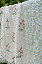 Jaipuri Quilt with floral motifs on a green background