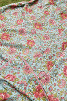 Floral fabric with pink flowers on a light blue background