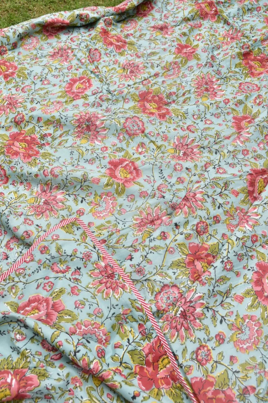 Floral fabric with pink flowers on a light blue background
