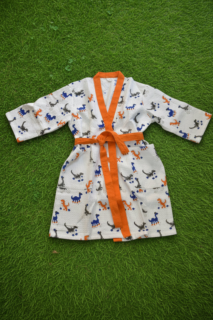 Children's outfit with a pattern of animals and an orange belt on a light gray surface