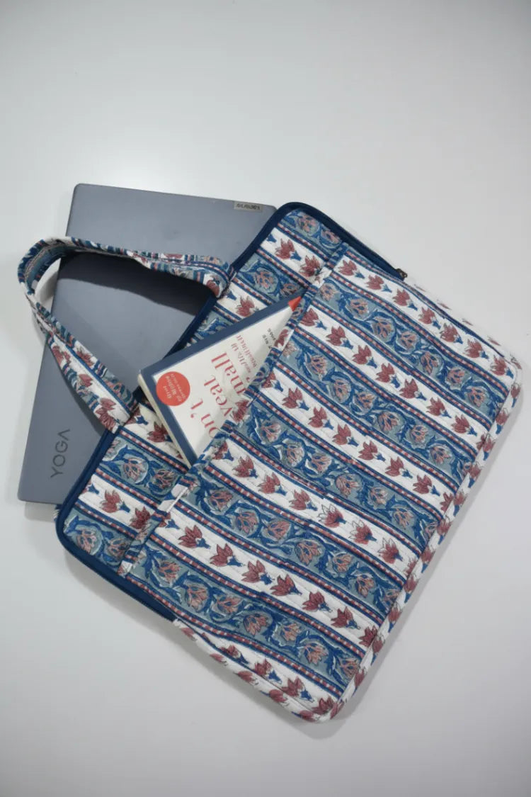 Floral patterned laptop sleeve with a gray device inside on a light gray background