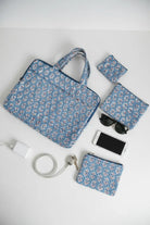 Set of blue floral bags and accessories on a white background