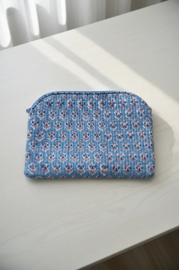 Blue floral-patterned pouch on a white surface
