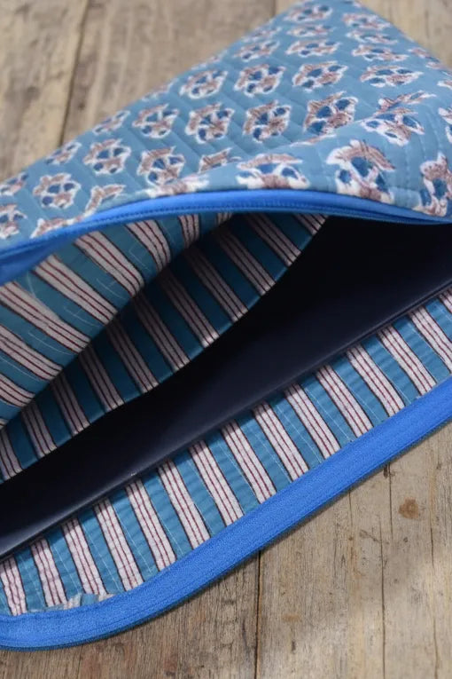 Folded fabric with blue border on a wooden surface