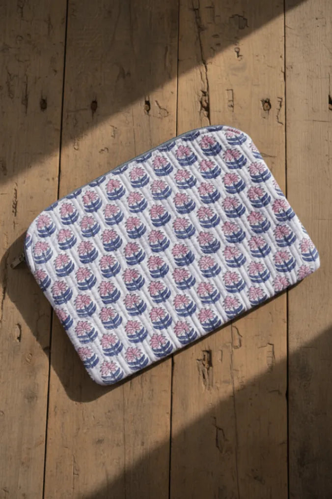 Patterned laptop bag and sleeve on a wooden surface