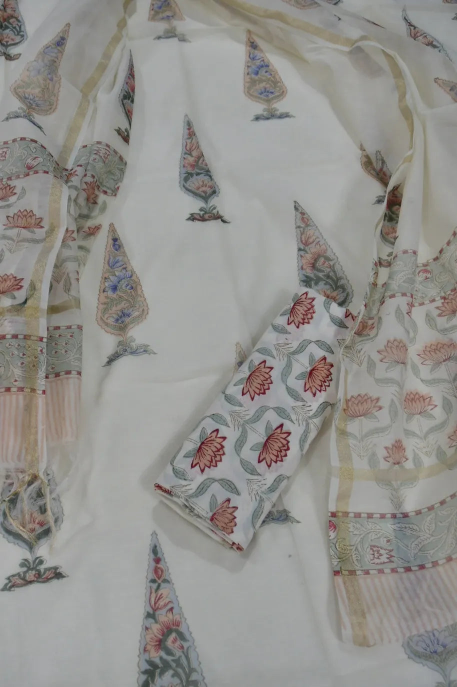 White chanderi with intricate floral patterns in red, green, and blue.