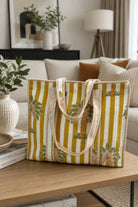 Striped tote bag with palm tree design on a coffee table in a living room.