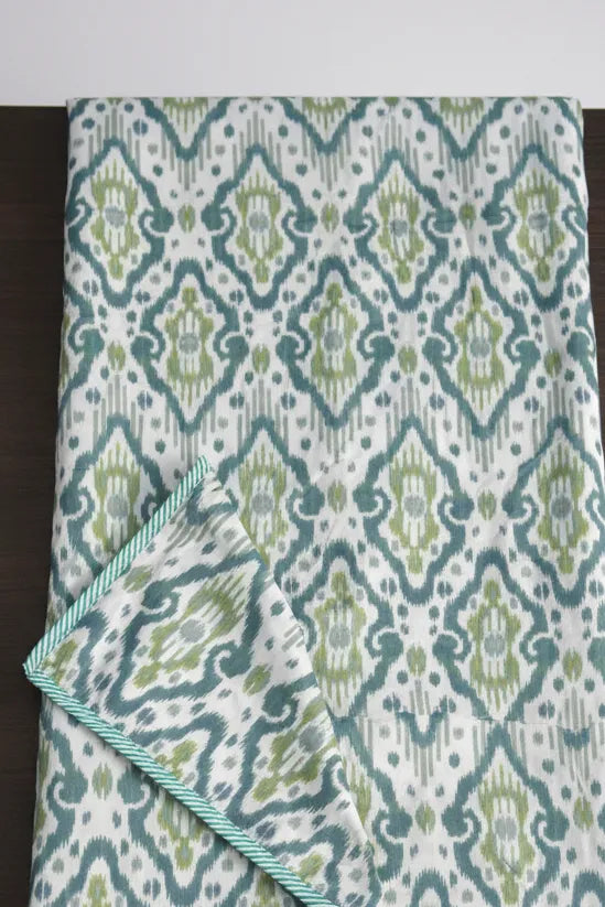 Patterned Dohar with green and blue design on a white background