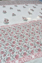 Floral patterned fabric with pink flowers on a white background