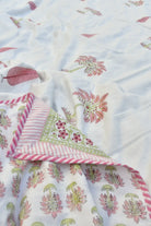 Floral patterned Dohar with pink and green accents on a white background