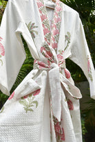 White paper towels with floral pattern on a green leafy background