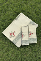 Set of decorative towels with floral patterns on a floral fabric background