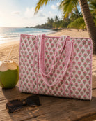 Floral patterned tote bag on a beach with palm trees and ocean in the background