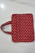 Red patterned bag on a white marble surface