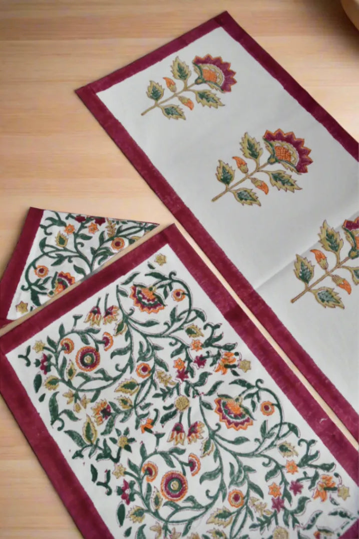 Decorative table runner with floral patterns on a wooden surface
