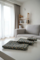 Folded floral-patterned fabric on a bed with floral bedding