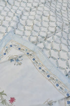 Close-up of embroidered fabric with floral patterns on a textured background