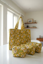 Yellow floral-patterned bags on a floral fabric background