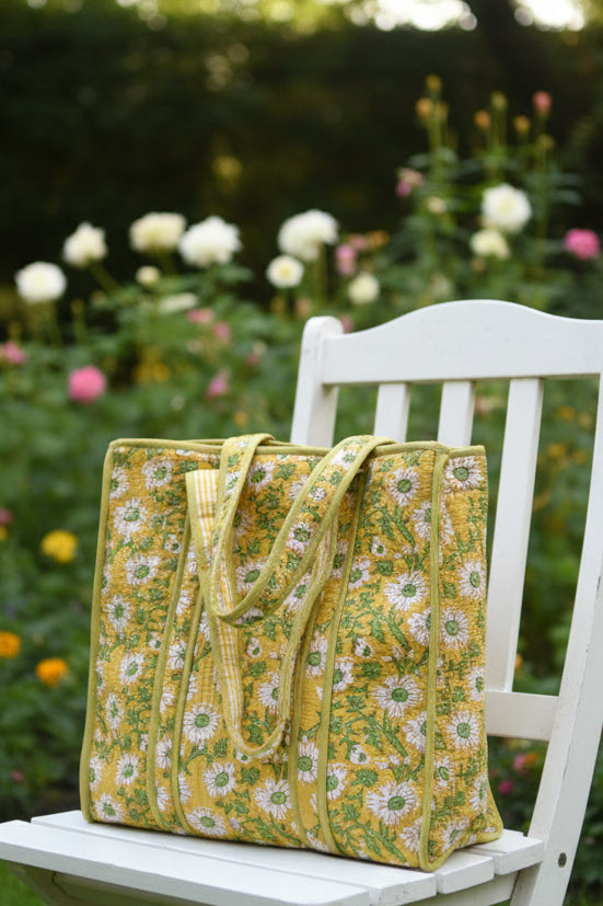 Yellow floral-patterned bag on a gray surface