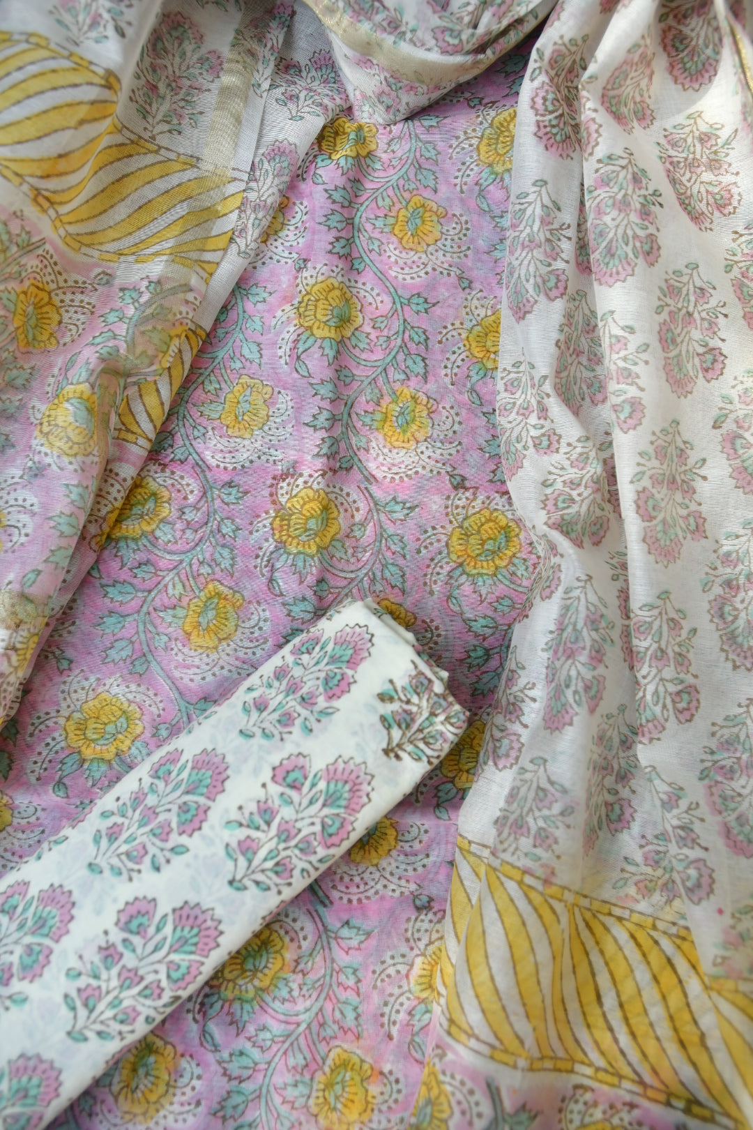 Floral patterned fabric with pink, yellow, and white colors.