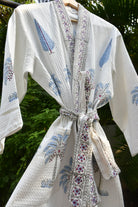 White fabric with floral patterns and a decorative bow on a green background