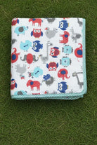 Folded dohar with animal pattern on a grassy background