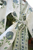 Close-up of a floral-patterned fabric with green and blue designs.