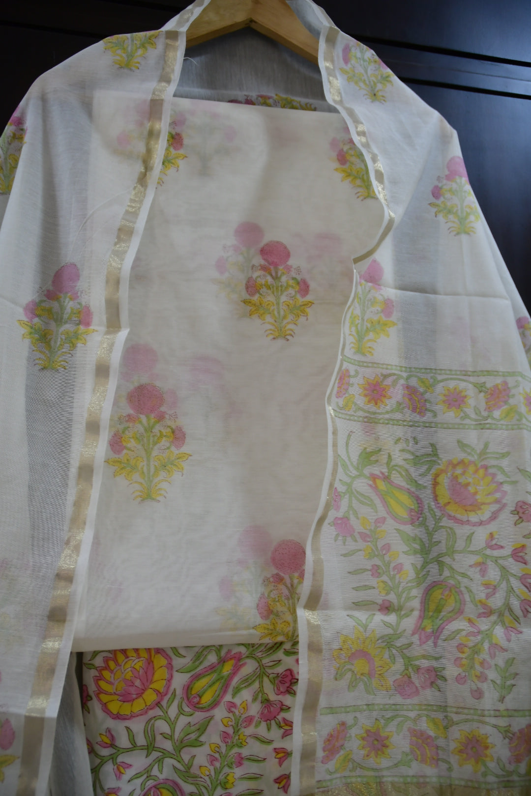 Floral-patterned fabric with a visible brand logo on a dark surface