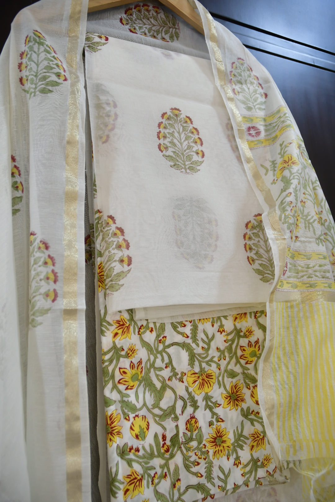 Floral fabric with green and yellow patterns on a white background