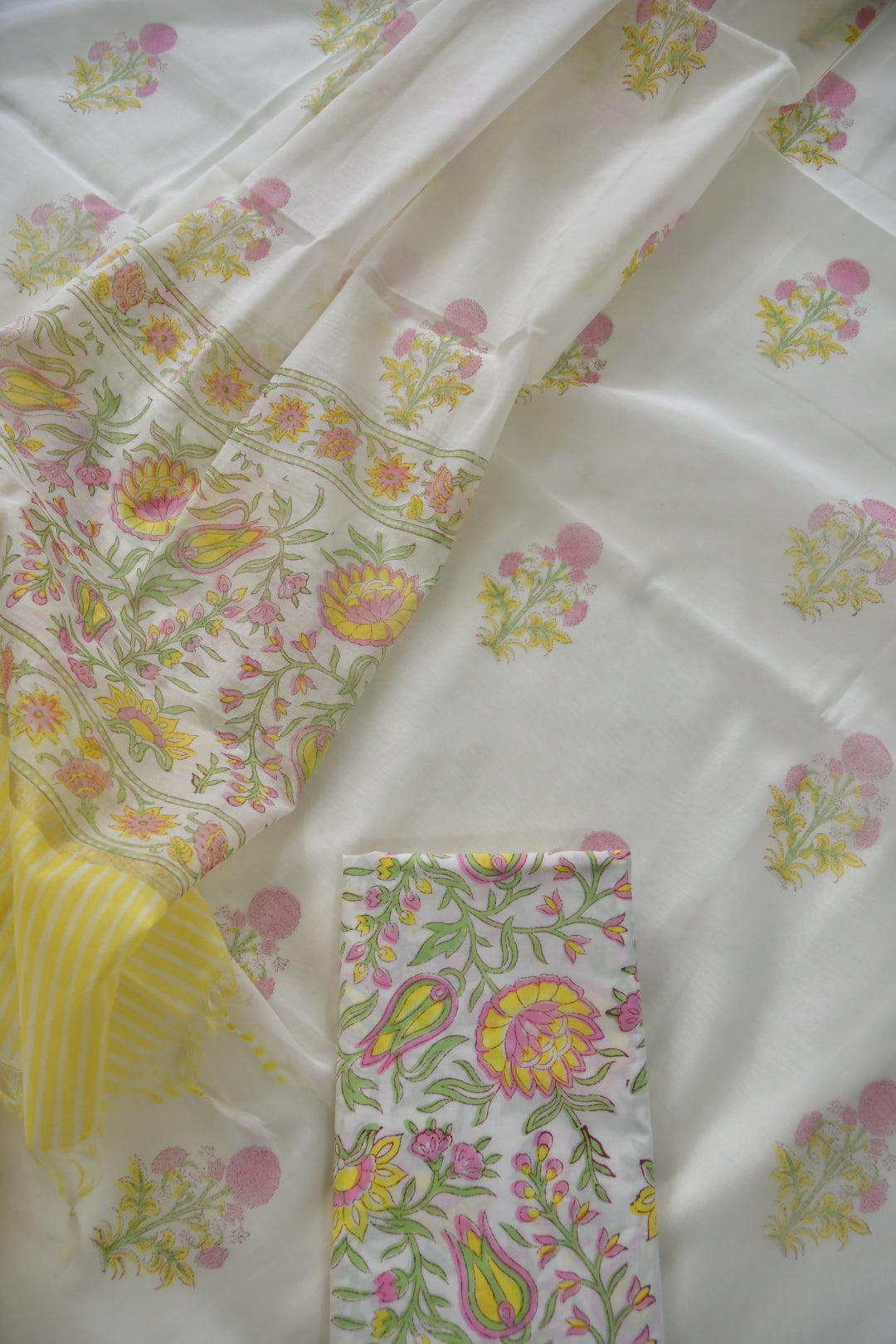 Floral patterned fabric with a yellow and white striped fabric swatch.